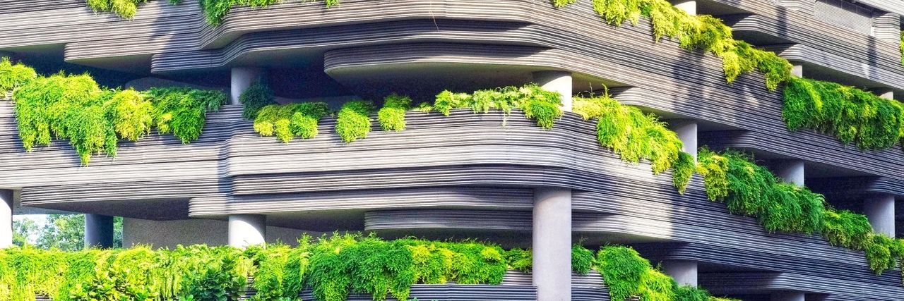 3D printed structure with lush green plants planted in between each floor of the building