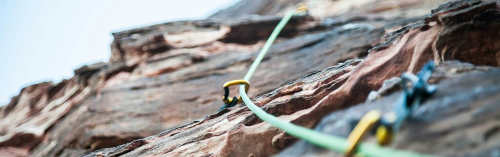 Rock wall with rope and caribiners 